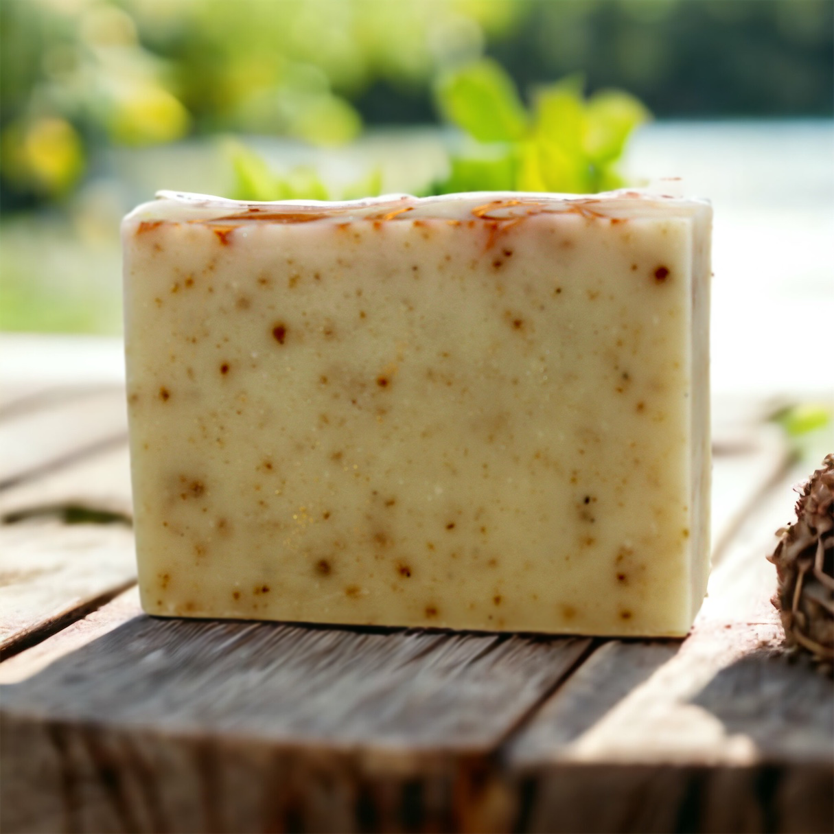 Patchouli Bar Soap Earth on rustic wood deck with garden in background Alpaca Soaps AlpacaSoaps
