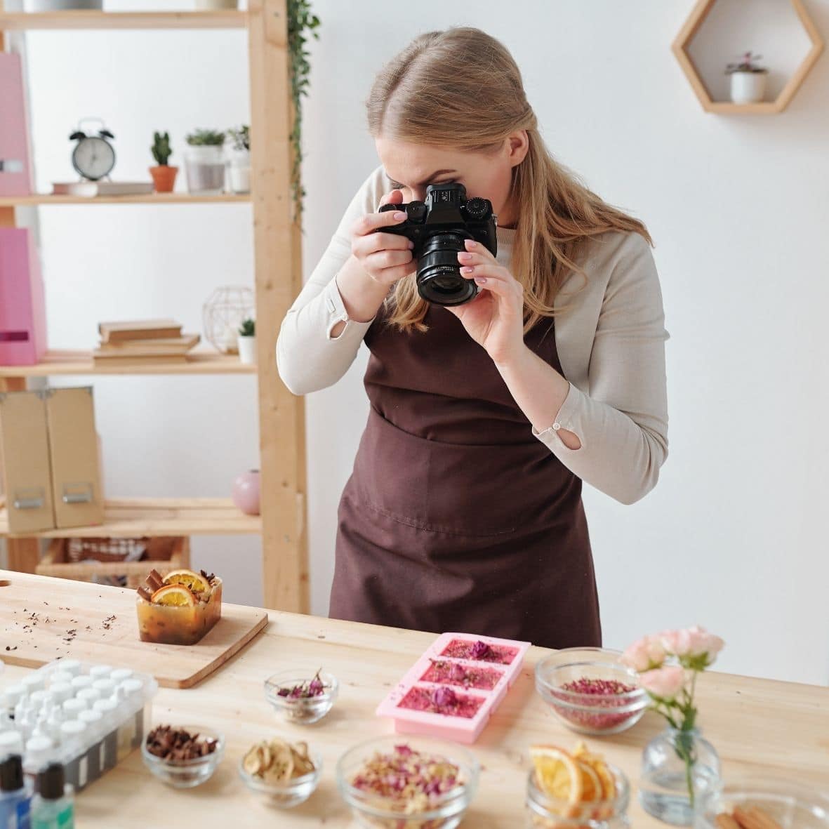 Image of woman taking photographs of products AlpacaSoaps Alpaca Soaps
