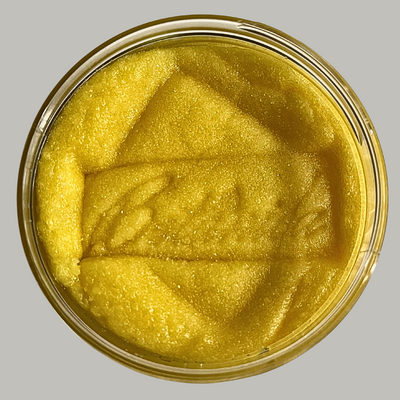 Open jar of sugar body scrub showing the texture, stamped Botanica AlpacaSoaps Alpaca Soaps, Yellow, Going Bananas Sugar Scrub