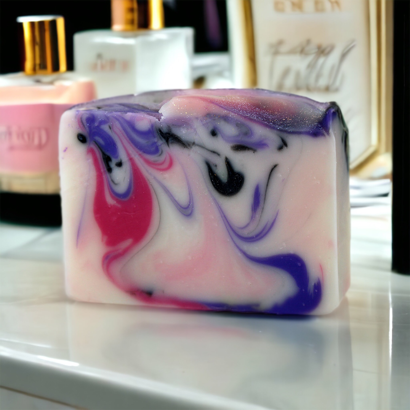 Femme Fatale Bar Soap on white marble counter with perfume bottles on the background, Alpaca Soaps AlpacaSoaps
