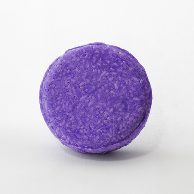 a round purple bath bomb on a white background