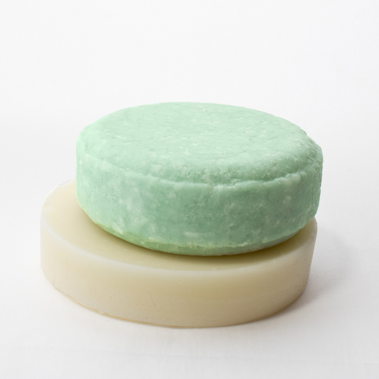 a round soap bar sitting on top of a white surface