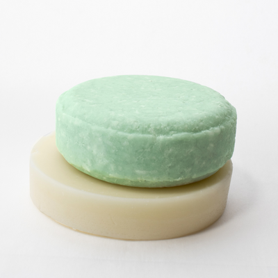 a round soap bar sitting on top of a white surface