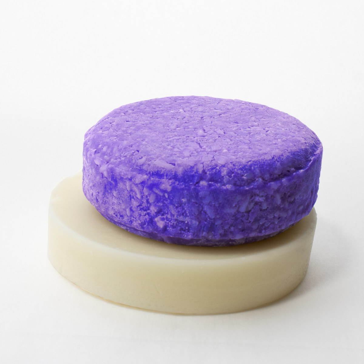 a purple sponge sitting on top of a soap bar