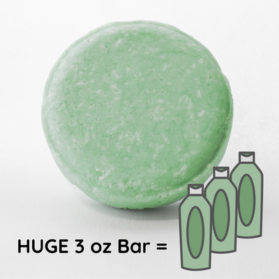 a green bath bomb next to three bottles of soap