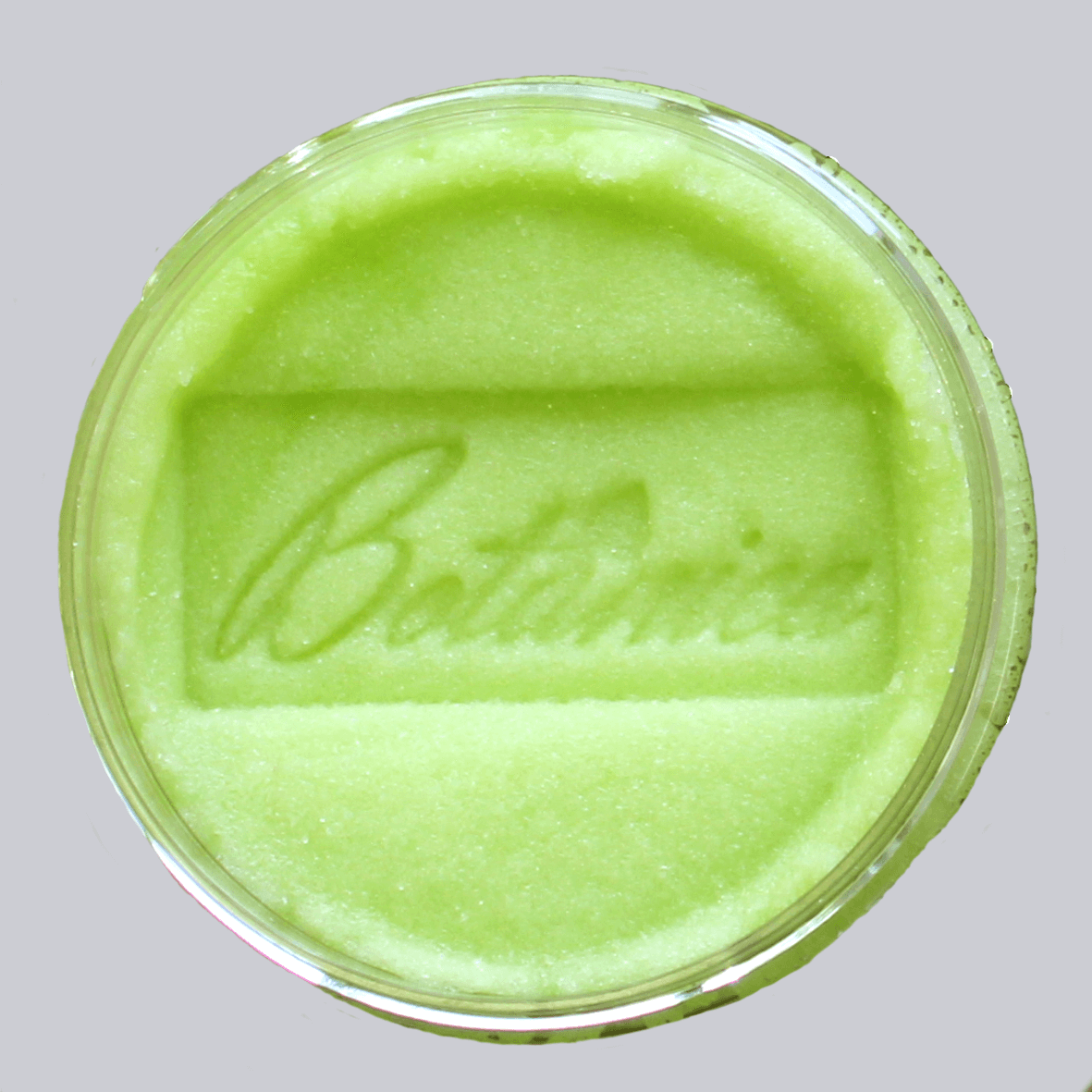 Open jar of sugar body scrub showing the texture, stamped Botanica AlpacaSoaps Alpaca Soaps, Lime green color Coconut Lime Verbena