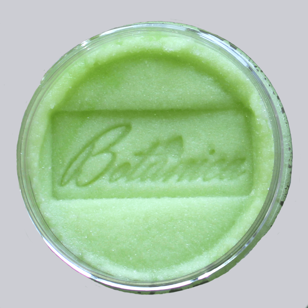 Open jar of sugar body scrub showing the texture, stamped "Botanica" AlpacaSoaps Alpaca Soaps, Soft green, Cucumber Melon