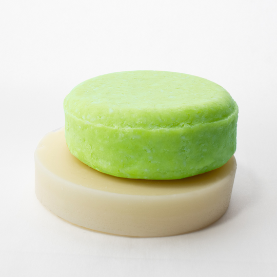 a green cake sitting on top of a white plate