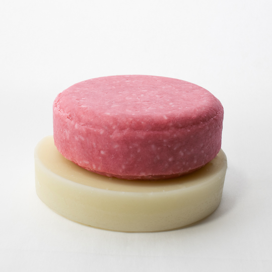 a pink cake sitting on top of a white plate